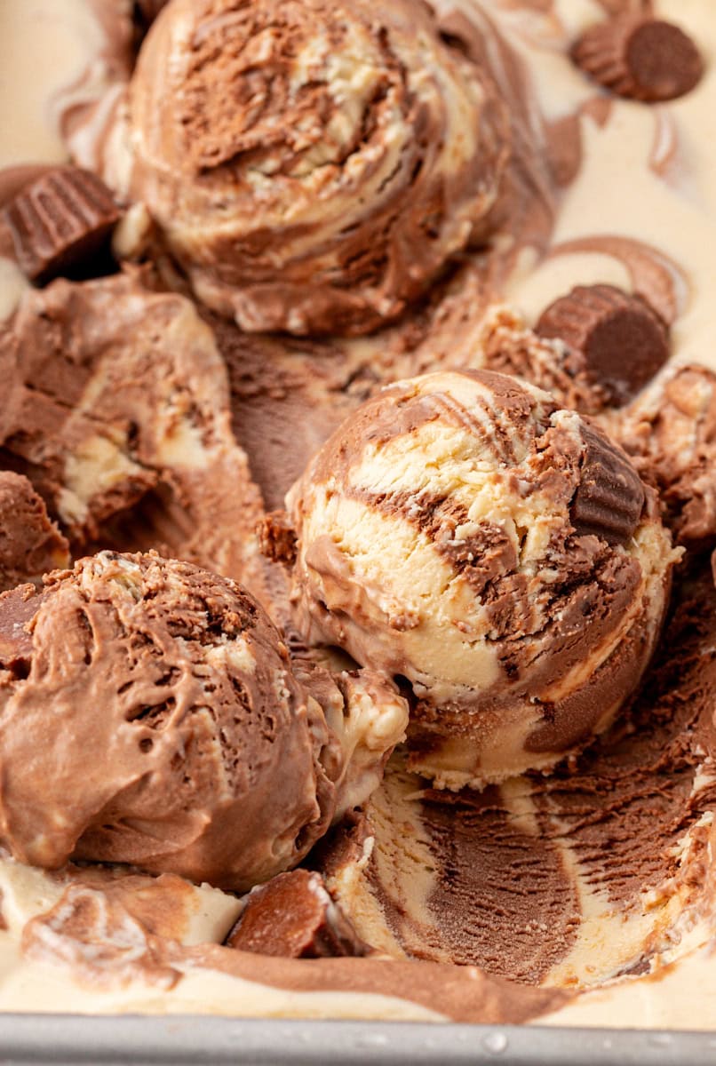 a few scoops of no-churn chocolate peanut butter ice cream on top of the remaining ice cream