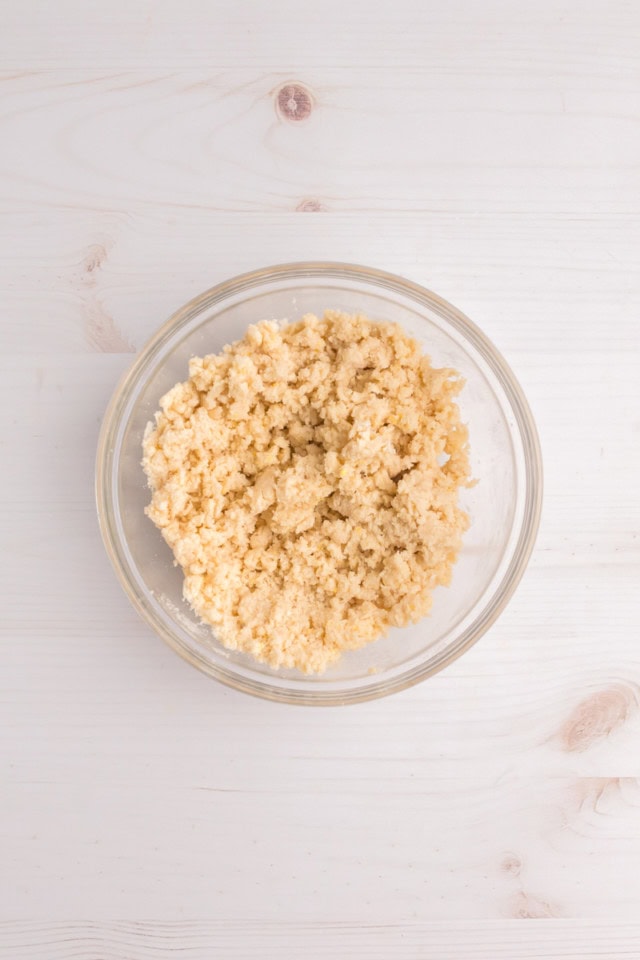 overhead view of mixed cobbler topping in a glass mixing bowl