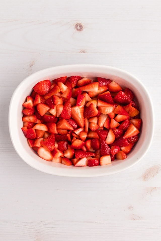 overhead view of strawberry cobbler filling in a baking dish