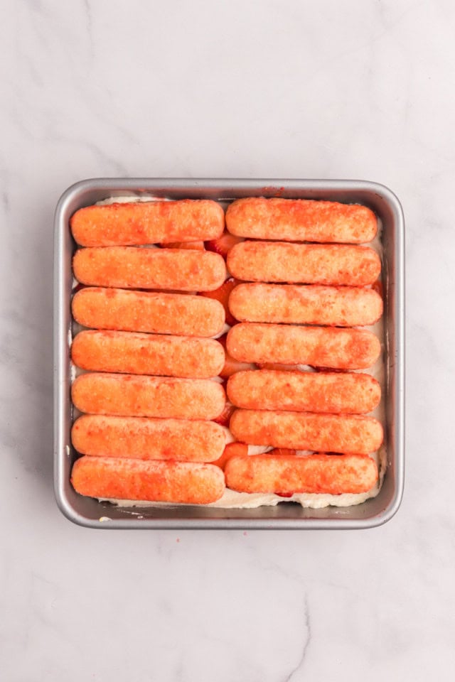 overhead view of the second layer of soaked ladyfingers for strawberry tiramisu