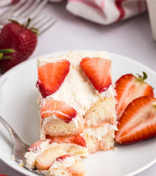 a slice of strawberry tiramisu on a plate with a bite on a fork
