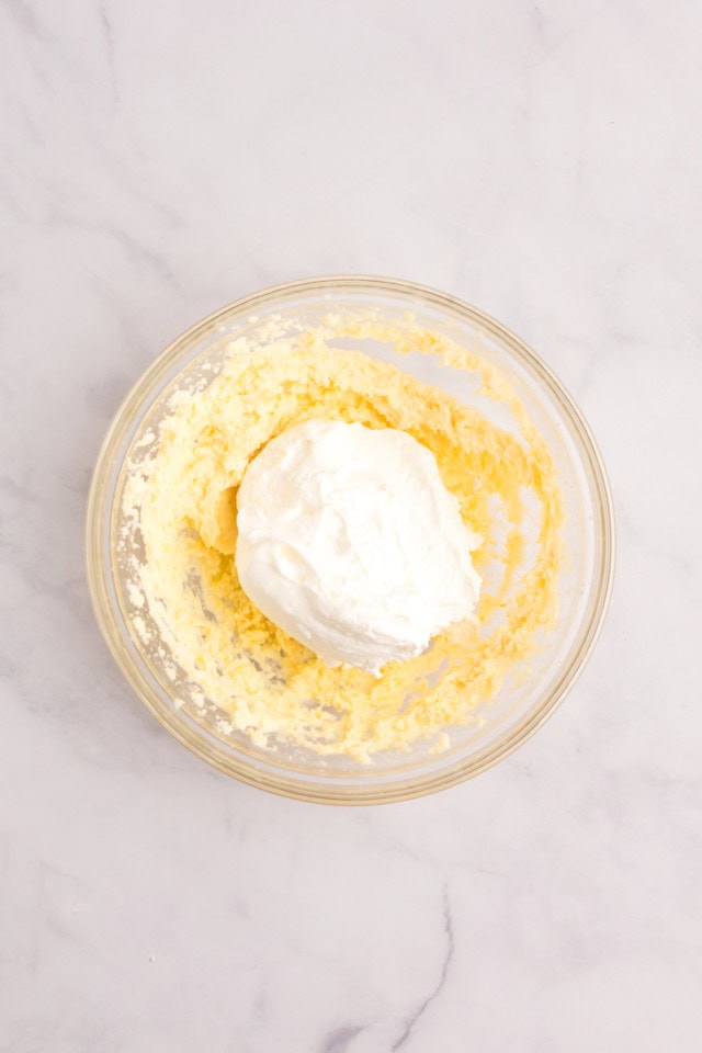 overhead view of whipped cream added to mascarpone mixture for strawberry tiramisu