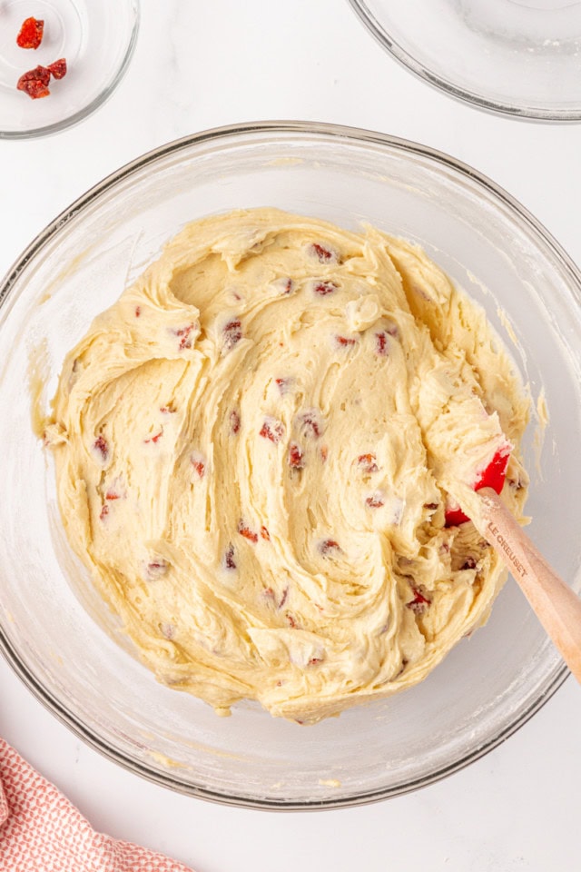 overhead view of strawberry cream cheese cookie dough in a glass mixing bowl