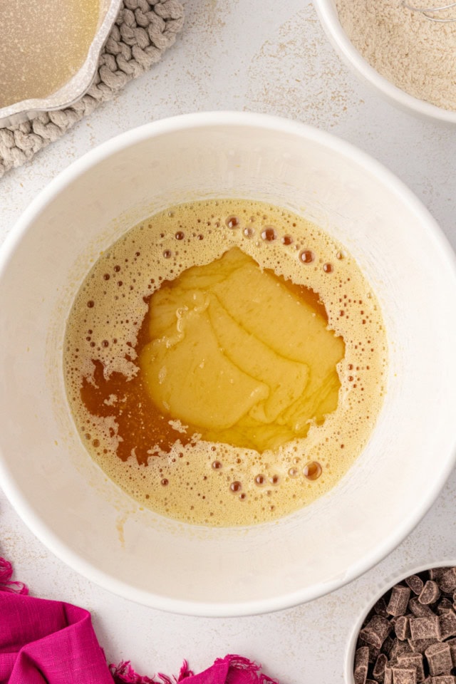 overhead view of melted white chocolate and butter added to egg and sugar mixture