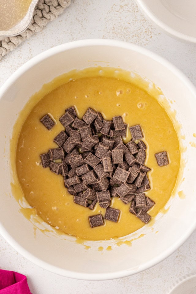 overhead view of chocolate chunks added to white chocolate brownie batter