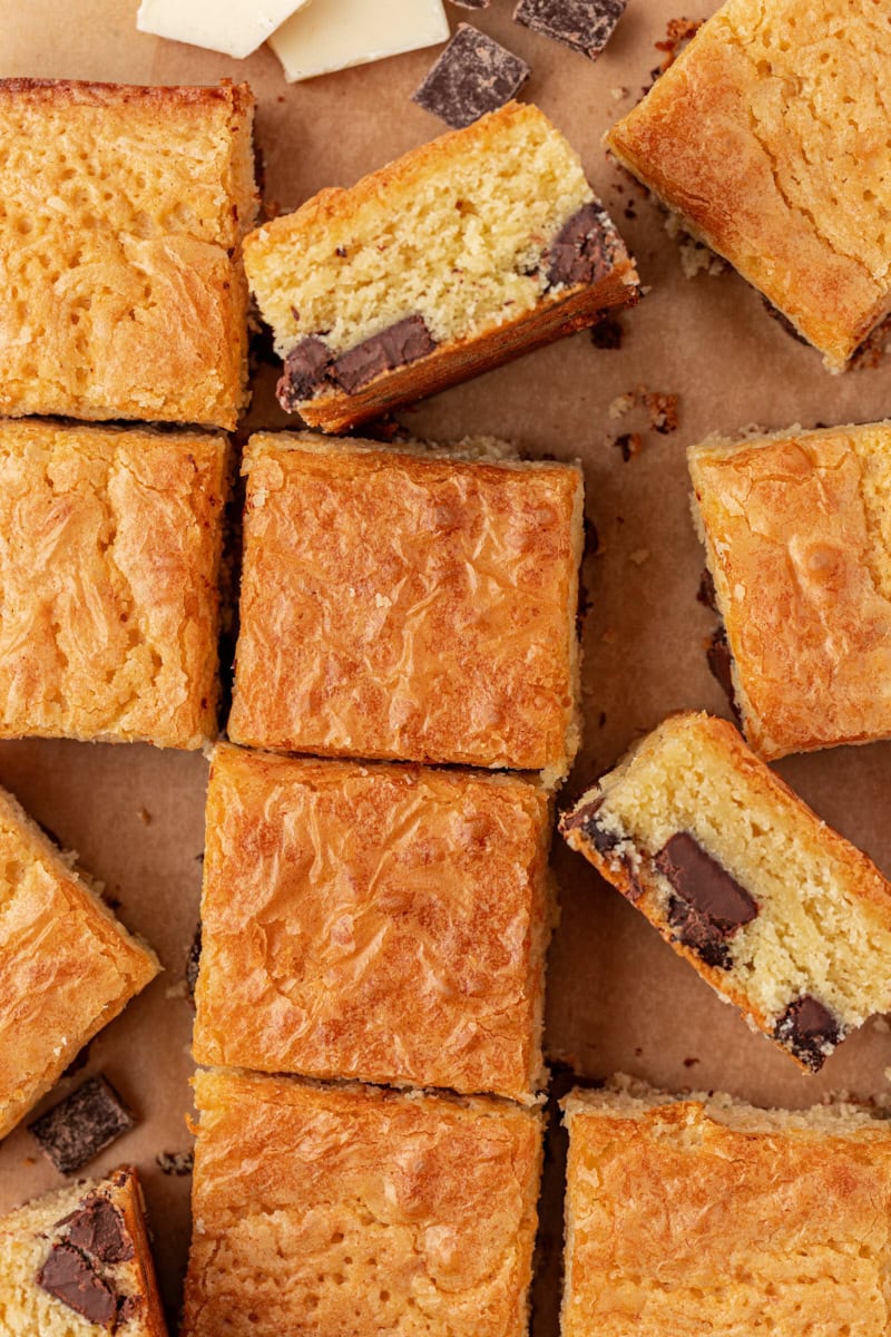 overhead view of sliced white chocolate brownies on parchment paper