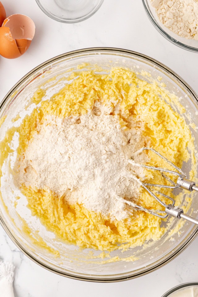 overhead view of dry ingredients added to wet ingredients for raspberry Bundt cake