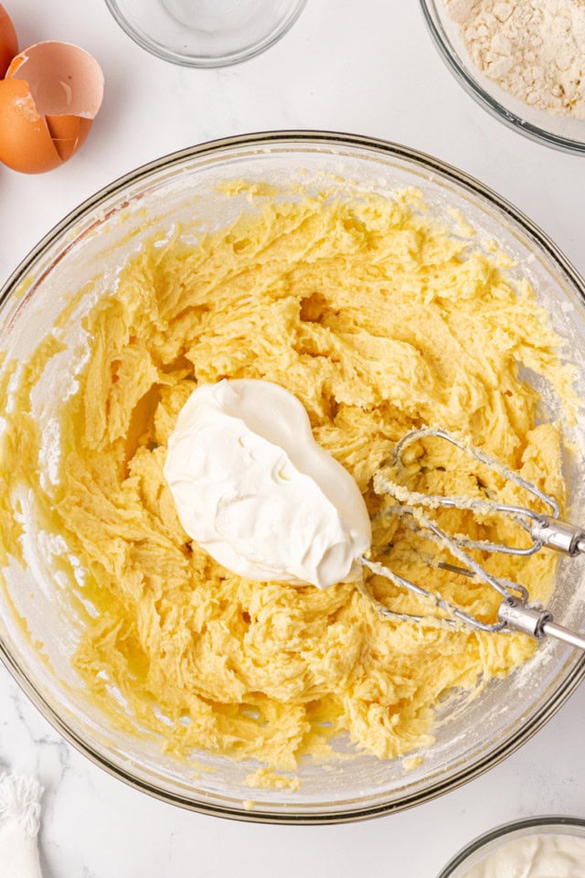 overhead view of sour cream added to cake batter