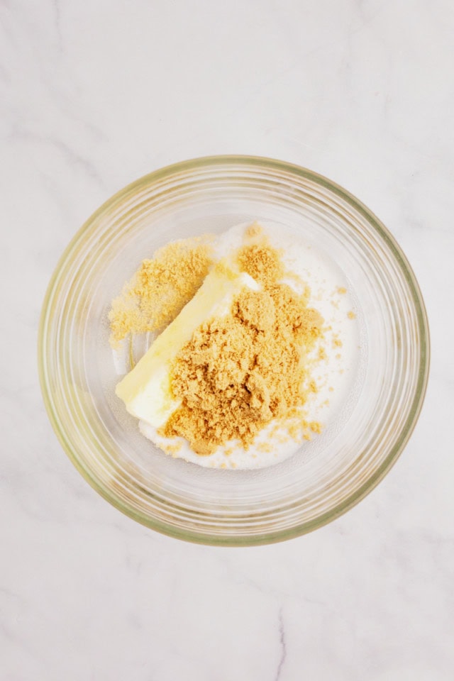 overhead view of butter, sugar, and brown sugar in a glass mixing bowl