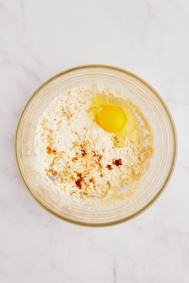 overhead view of egg and vanilla added to creamed butter and sugar