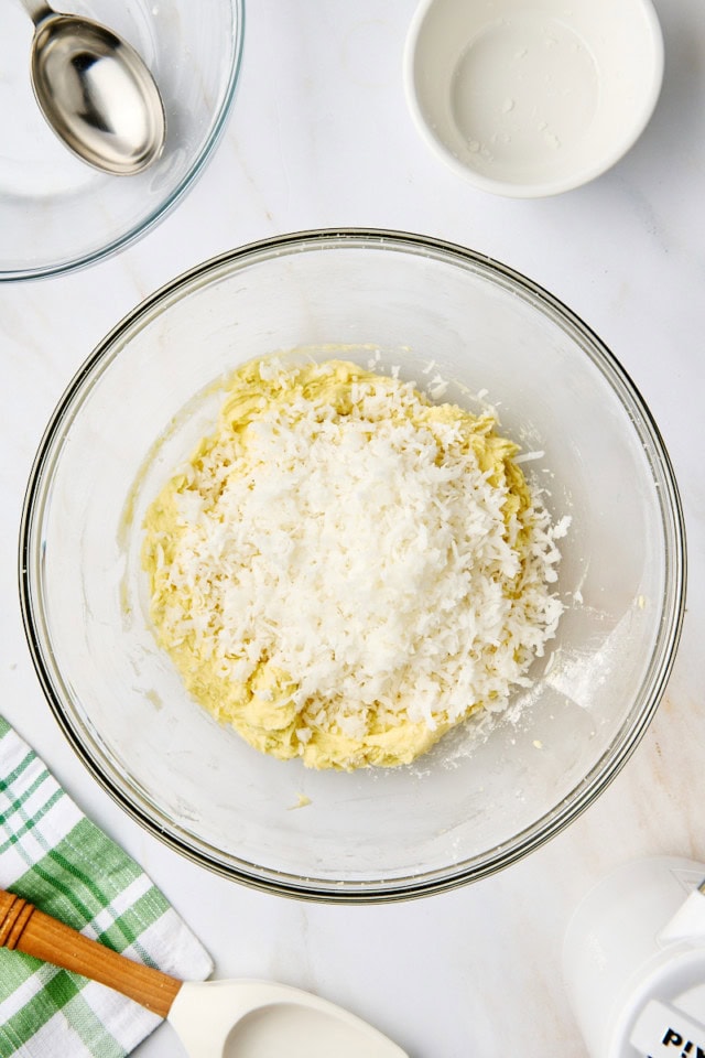 overhead view of dry ingredients added to wet ingredients for coconut lime cookies