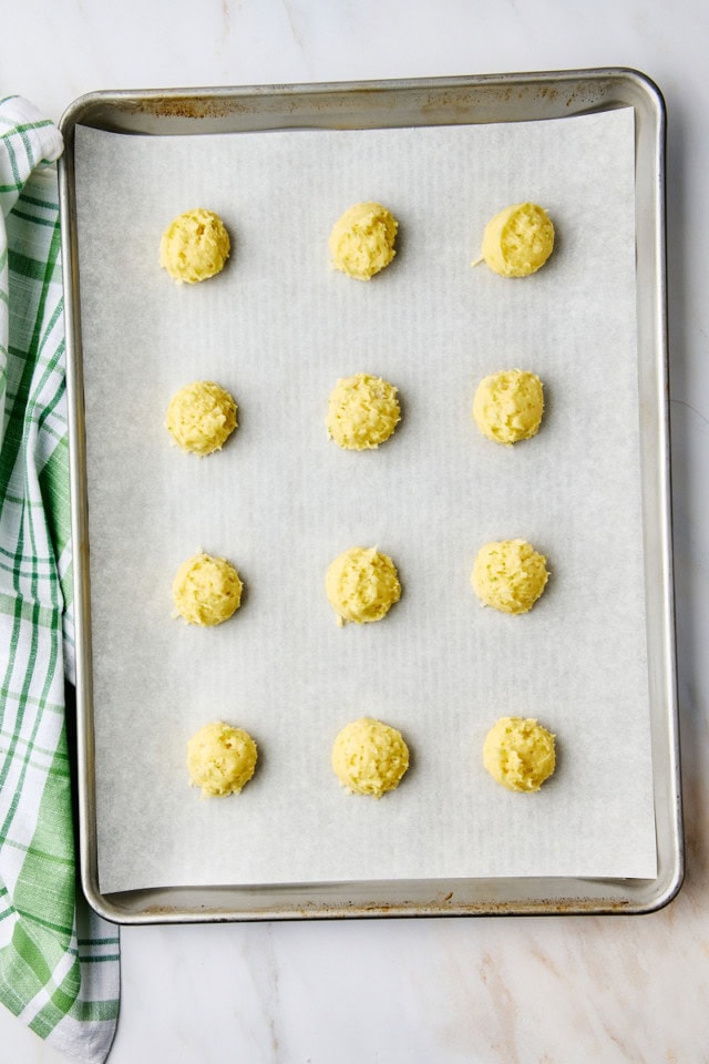 overhead view of coconut lime cookie dough on a parchment-lined baking sheet ready to go into the oven