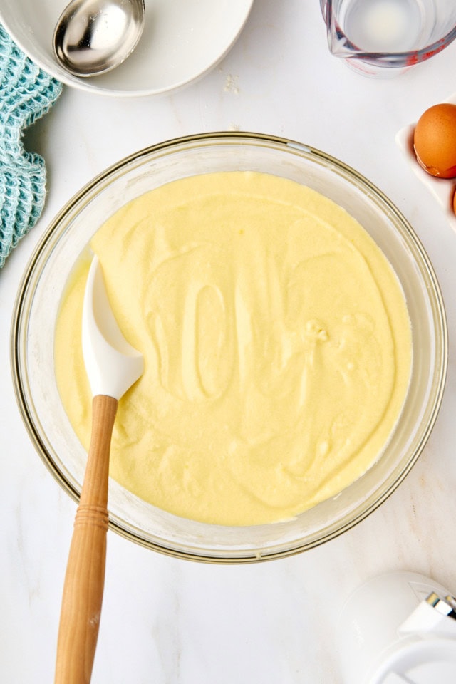 overhead view of five flavor pound cake batter in a glass mixing bowl