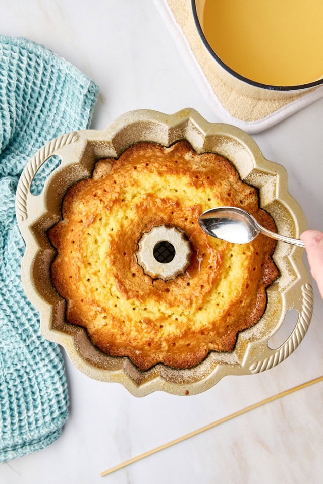 overhead view of glaze being spooned over five flavor pound cake