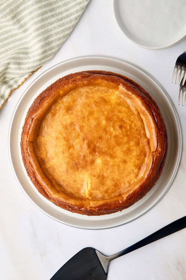 overhead view of New York cheesecake on a metal cake stand