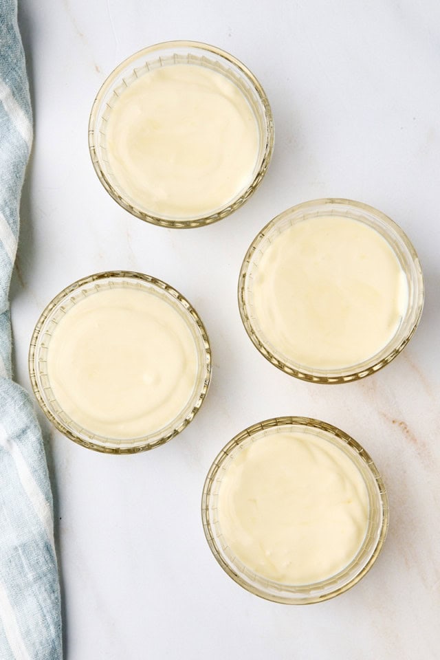 overhead view of ricotta mousse portioned into clear glass ramekins