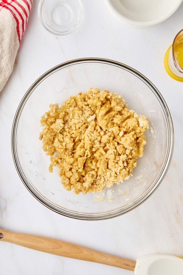 overhead view of crumb topping mixture in a glass mixing bowl