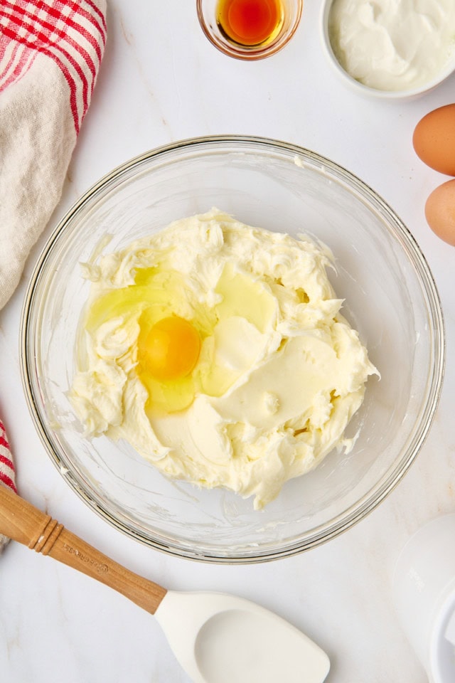 overhead view of egg added to beaten cream cheese and sugar