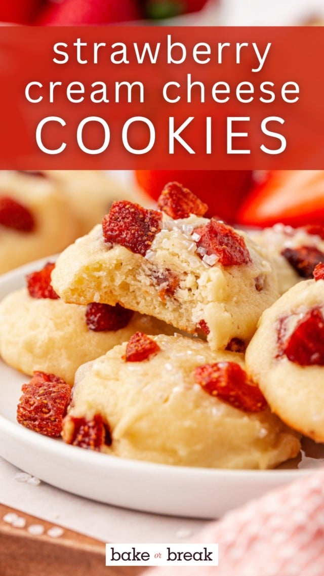 a mounded stack of strawberry cream cheese cookies with a bite missing from the top cookie; text overlay "strawberry cream cheese cookies"