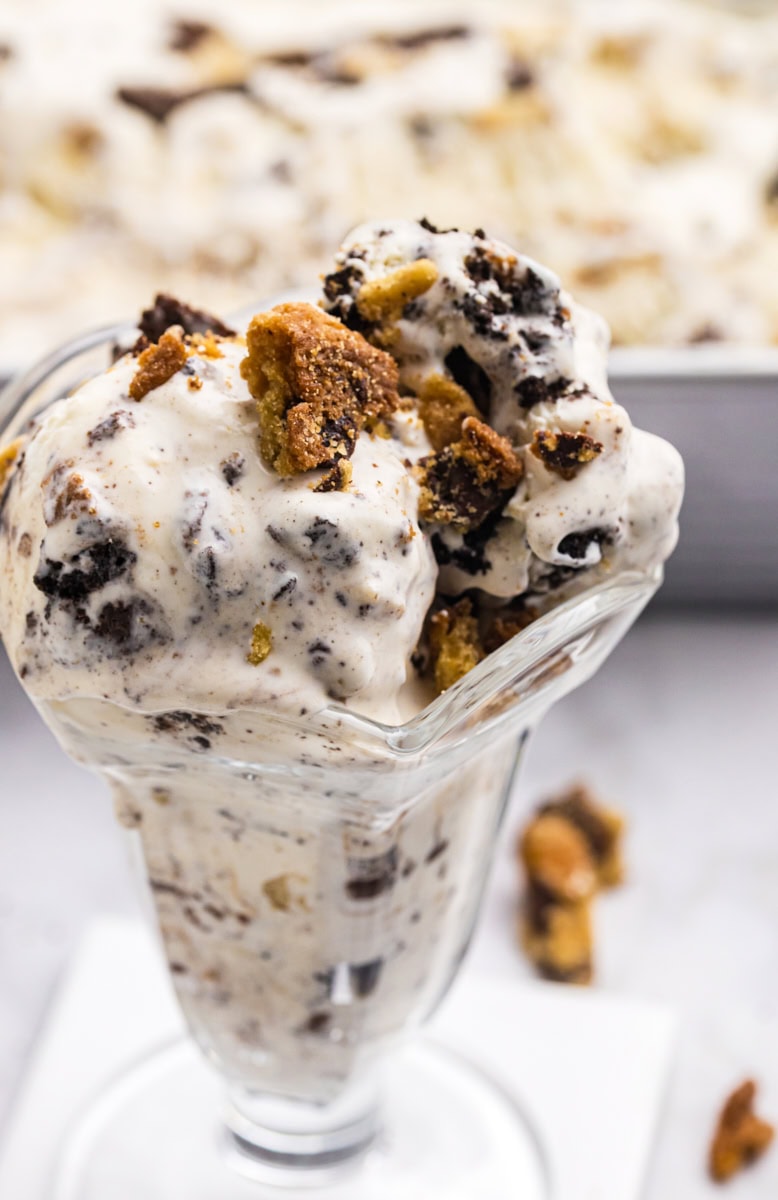 all the cookies ice cream in a serving glass with remaining ice cream in the background