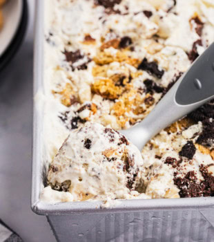 all the cookies ice cream in a metal loaf pan with a scoop resting in the corner