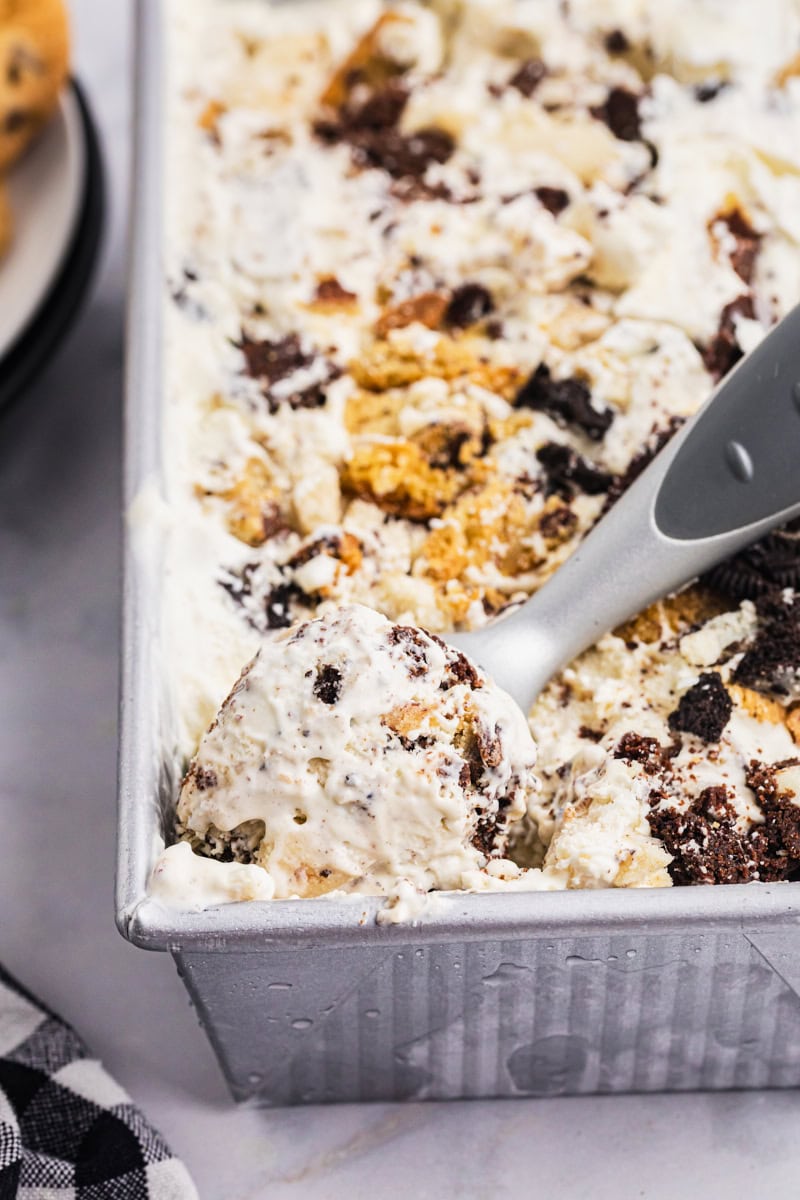 all the cookies ice cream in a metal loaf pan with a scoop resting in the corner