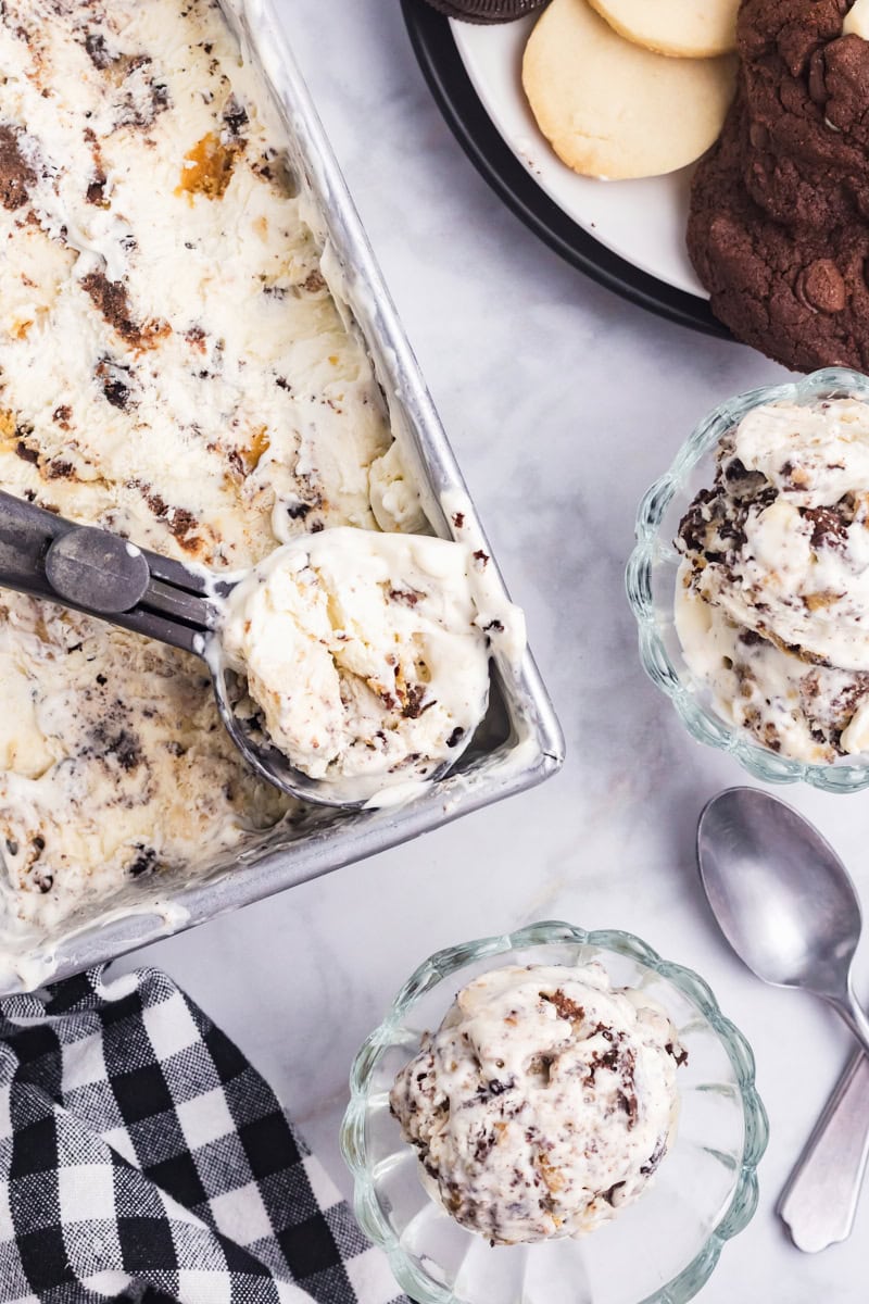 overhead view of all the cookies ice cream in bowls and in a scoop resting on the container of ice cream