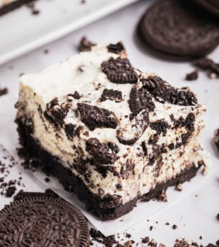 an Oreo cheesecake bar on a white surface