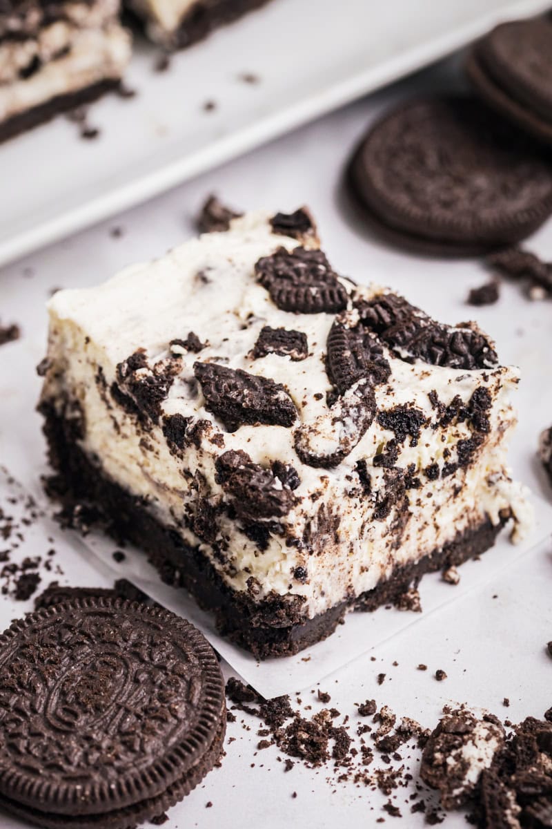 an Oreo cheesecake bar on a white surface