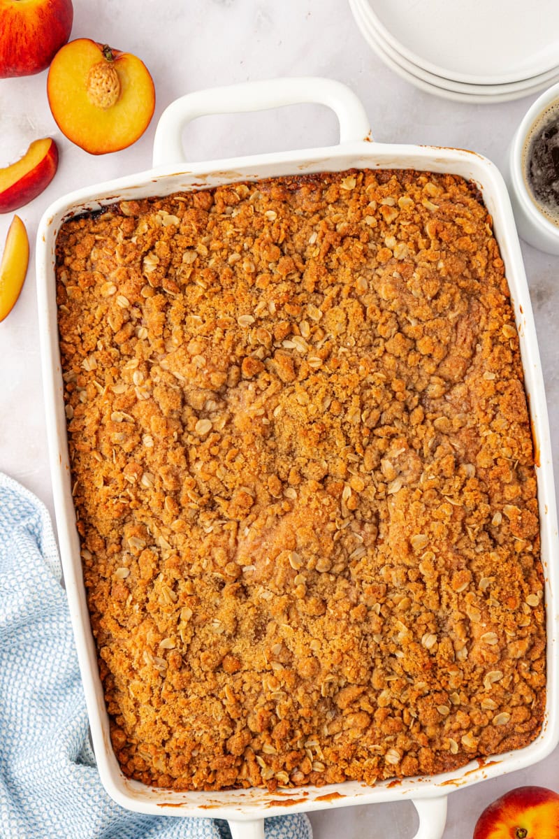 overhead view of freshly baked peach coffee cake in a rectangular pan