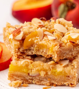 stack of two peach bars with a bite missing from the top bar