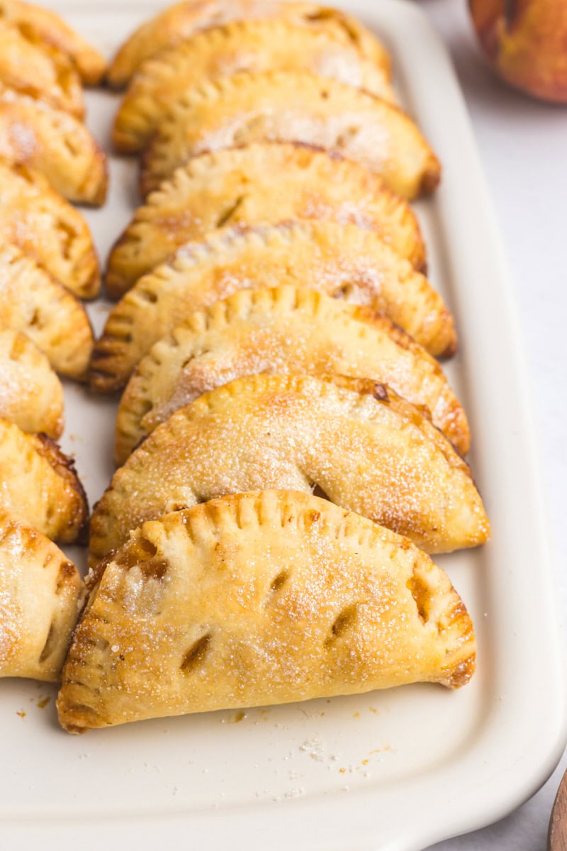 peach hand pies on a white serving tray