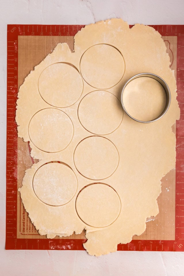 overhead view of rolled cream cheese pastry dough being cut into rounds