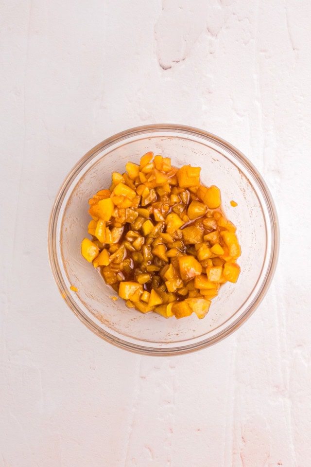 overhead view of mixed filling for peach hand pies in a glass bowl