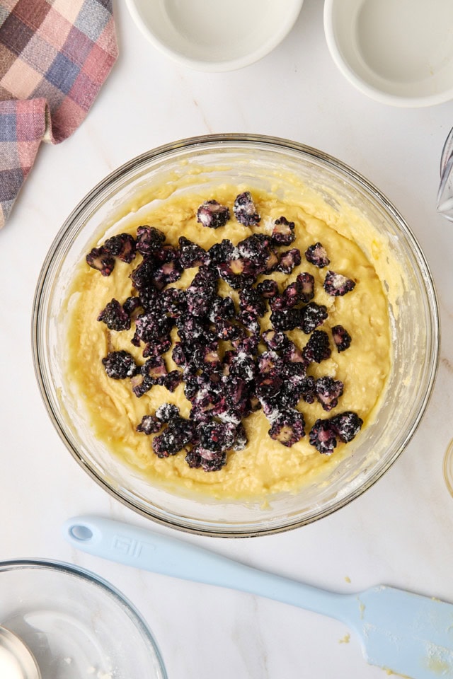 overhead view of chopped blackberries added to muffin batter