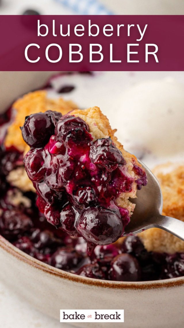 a spoonful of blueberry cobbler held above a bowl of cobbler; text overlay "blueberry cobbler"