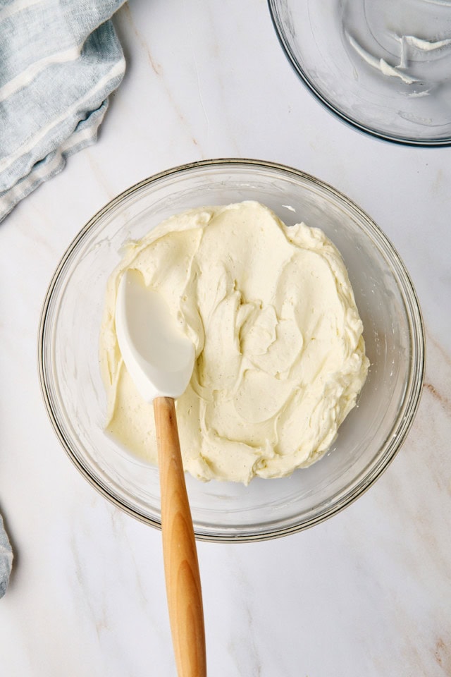 overhead view of no-bake cheesecake filling in a glass mixing bowl