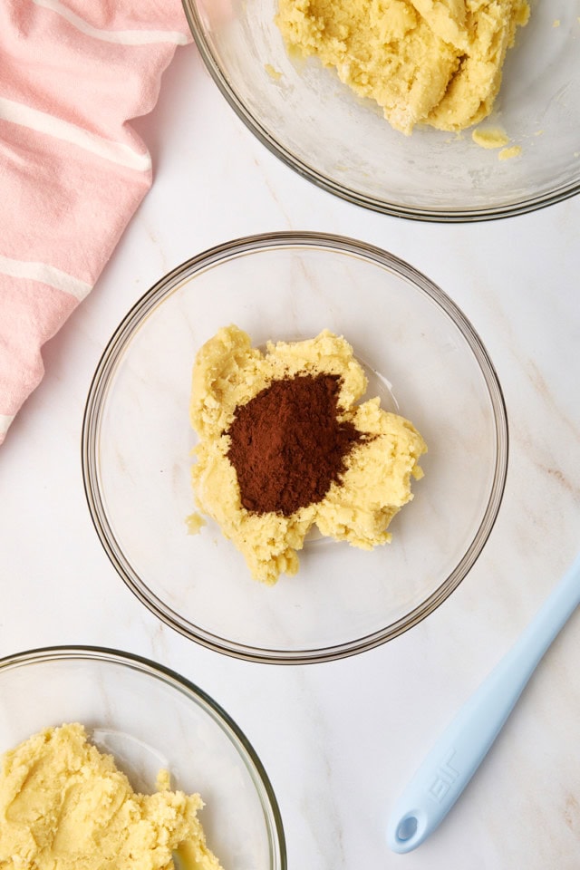 overhead view of cocoa powder added to sugar cookie dough