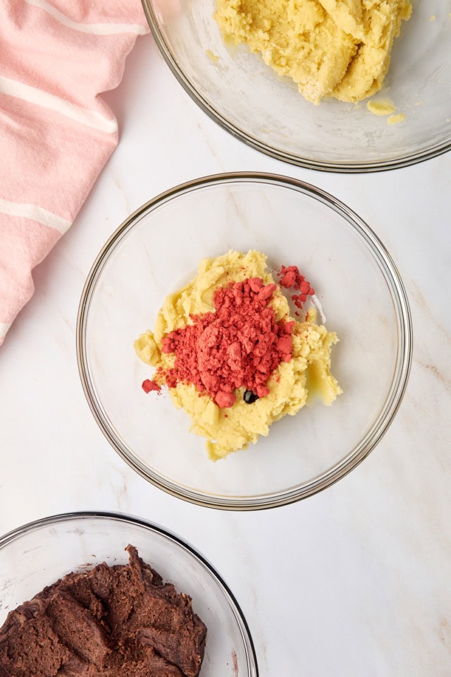 overhead view of raspberry powder and food coloring added to sugar cookie dough