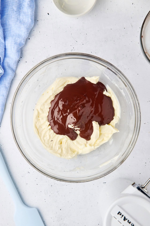 overhead view of melted chocolate added to cream cheese mixture for cheesecake batter