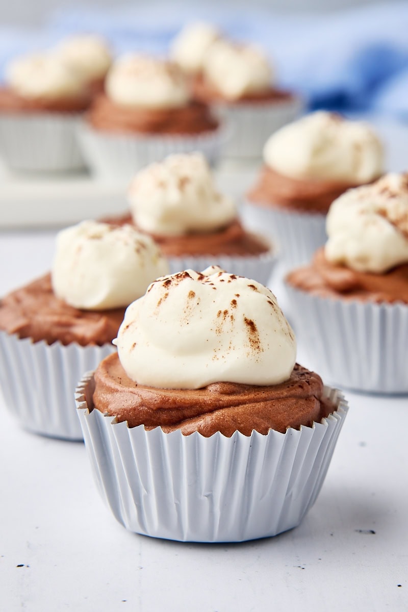 close-up view of a mini no-bake chocolate cheesecake with more cheesecakes in the background