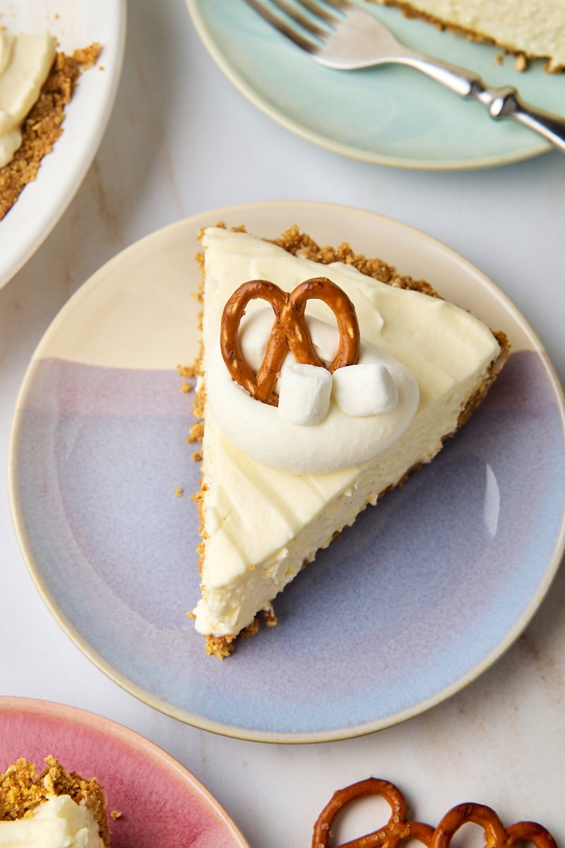 a slice of no-bake marshmallow cheesecake on a purple and white plate