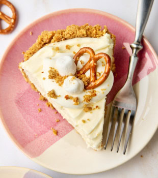 overhead view of a slice of no-bake marshmallow cheesecake on a pink and white plate