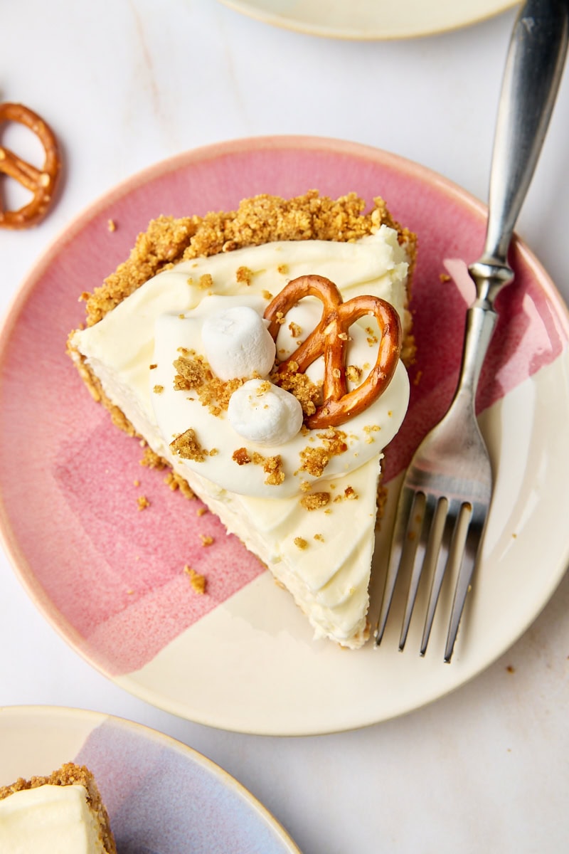 overhead view of a slice of no-bake marshmallow cheesecake on a pink and white plate