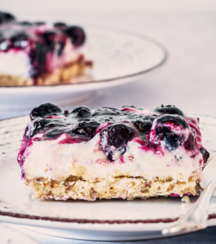 slice of Blueberry Jamboree on a white and gray plate