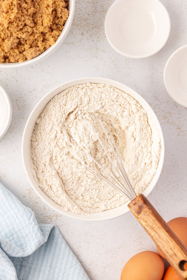 overhead view of flour, baking powder, and salt mixed in a white bowl