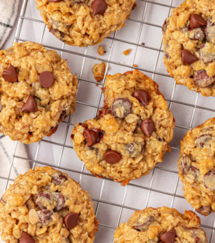 brown sugar oatmeal chocolate chip cookies on a wire rack with a bite missing from the center cookie