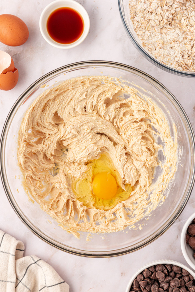 overhead view of egg added to creamed butter and brown sugar