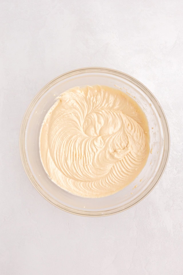 overhead view of vanilla cupcake batter in a glass mixing bowl