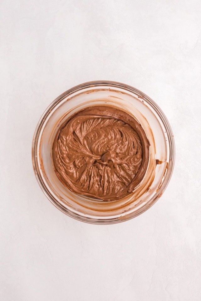 overhead view of chocolate cupcake batter in a glass mixing bowl